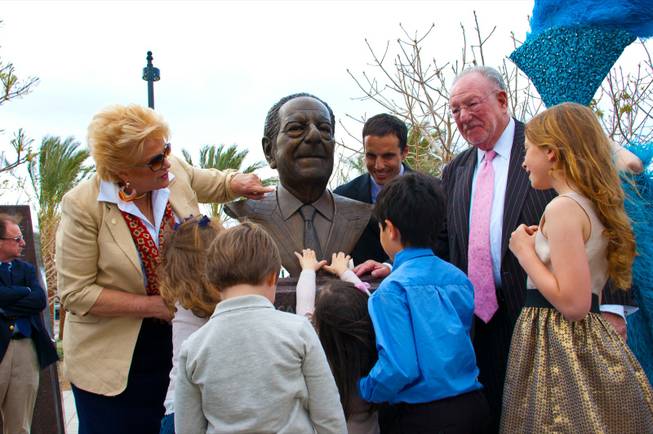 The Goodman family gather around a bronze bust created in his likeness of Oscar Goodman, Monday March, 12 2012.